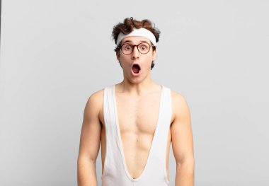 humorous sport man looking very shocked or surprised, staring with open mouth saying wow