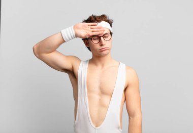 humorous sport man looking stressed, tired and frustrated, drying sweat off forehead, feeling hopeless and exhausted