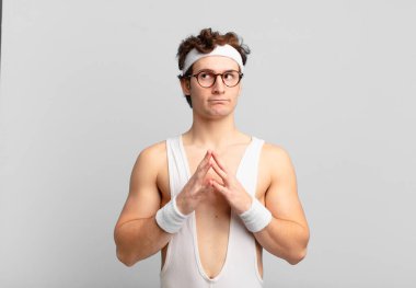 humorous sport man feeling proud, mischievous and arrogant while scheming an evil plan or thinking of a trick