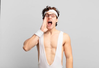 humorous sport man profile view, looking happy and excited, shouting and calling to copy space on the side