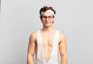 humorous sport man smiling positively and confidently, looking satisfied, friendly and happy