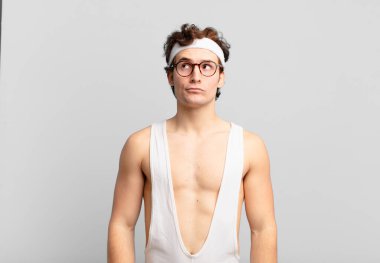 humorous sport man looking puzzled and confused, wondering or trying to solve a problem or thinking
