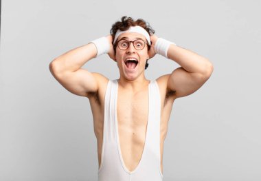 humorous sport man looking happy, carefree, friendly and relaxed enjoying life and success, with a positive attitude