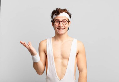 humorous sport man feeling happy, surprised and cheerful, smiling with positive attitude, realizing a solution or idea