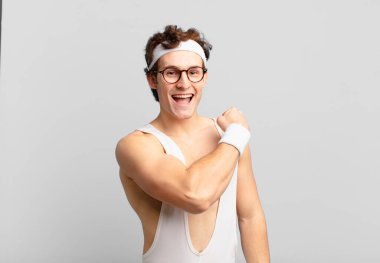humorous sport man feeling happy, positive and successful, motivated when facing a challenge or celebrating good results