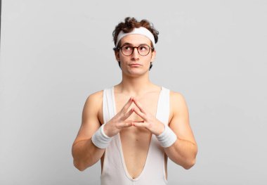 humorous sport man scheming and conspiring, thinking devious tricks and cheats, cunning and betraying