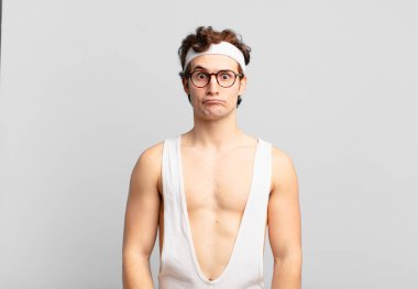 humorous sport man feeling confused and doubtful, wondering or trying to choose or make a decision