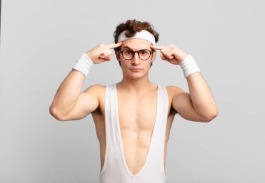 humorous sport man with a serious and concentrated look, brainstorming and thinking about a challenging problem