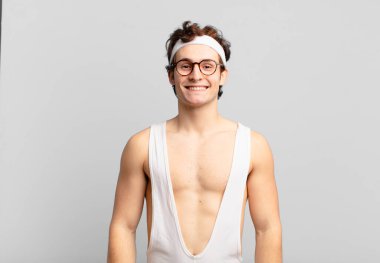 humorous sport man smiling cheerfully and casually with a positive, happy, confident and relaxed expression