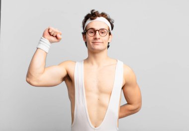 humorous sport man feeling serious, strong and rebellious, raising fist up, protesting or fighting for revolution