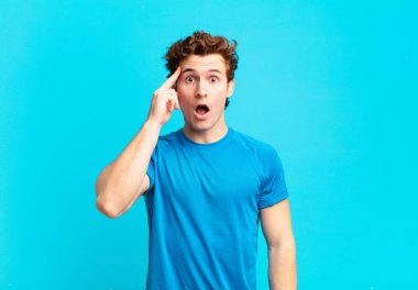 Genç sporcu çocuk şaşırmış, ağzı açık, şok olmuş, yeni bir düşünce, fikir ya da konsept keşfediyor.