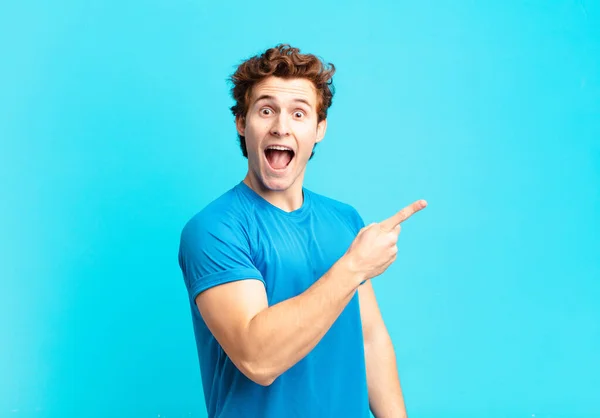 Young Sport Boy Looking Excited Surprised Pointing Side Upwards Copy — Stock Photo, Image