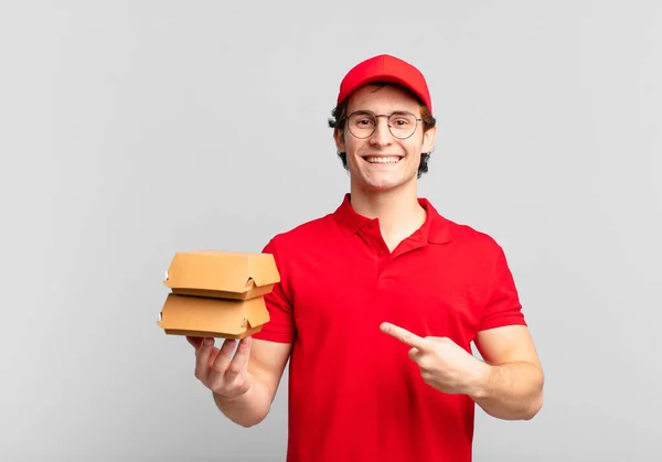 Burgers Deliver Boy Smiling Cheerfully Feeling Happy Pointing Side Upwards — Stock Photo, Image