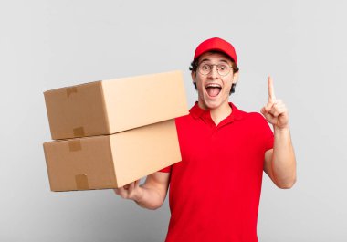 Paket teslimatı yapan çocuk bir fikri fark ettikten sonra mutlu ve heyecanlı bir dahi gibi hissetti. Neşeli bir şekilde parmağını kaldırdı.!