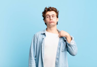 Genç yakışıklı çocuk stresli, endişeli, yorgun ve hayal kırıklığına uğramış, gömleğini çekmiş, sıkıntılı görünüyor.