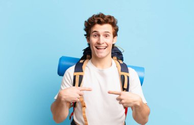 Yürüyüşçü çocuk mutlu, şaşkın ve gururlu, heyecanlı, şaşkın bakışlarıyla kendini işaret ediyor.