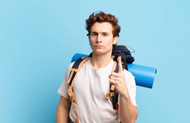 Yürüyüş çocuğu kızgın, sinirli, asi ve agresif hissediyor, orta parmağını sallıyor, karşı koyuyor.