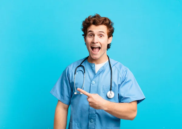 Young Nurse Man Looking Excited Surprised Pointing Side Upwards Copy — Stock Photo, Image