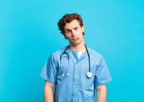 Young Nurse Man Feeling Puzzled Confused Dumb Stunned Expression Looking — 스톡 사진