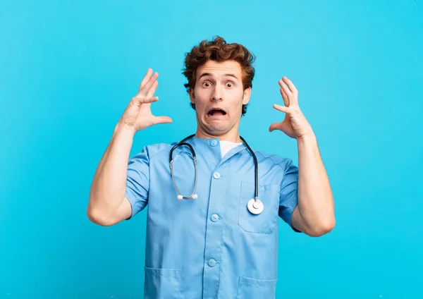 Young Nurse Man Screaming Hands Air Feeling Furious Frustrated Stressed — Stock Fotó