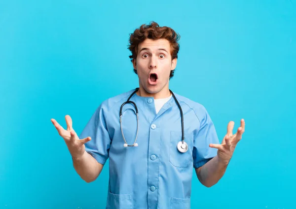 Young Nurse Man Feeling Extremely Shocked Surprised Anxious Panicking Stressed — Stock Photo, Image