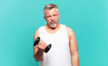 senior athlete man feeling puzzled and confused, with a dumb, stunned expression looking at something unexpected