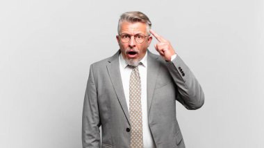 Kıdemli işadamı şaşırmış, ağzı açık, şok olmuş, yeni bir düşünce, fikir ya da konsept keşfediyor.