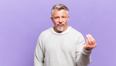 old senior man making capice or money gesture, telling you to pay your debts!