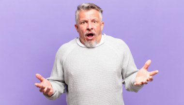 old senior man open-mouthed and amazed, shocked and astonished with an unbelievable surprise