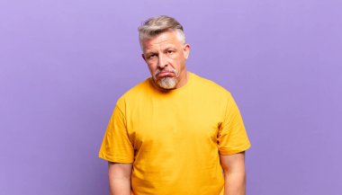 old senior man feeling puzzled and confused, with a dumb, stunned expression looking at something unexpected