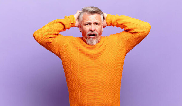 old senior man feeling stressed, worried, anxious or scared, with hands on head, panicking at mistake