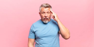 old senior man looking surprised, open-mouthed, shocked, realizing a new thought, idea or concept