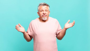 old senior man feeling puzzled and confused, doubting, weighting or choosing different options with funny expression