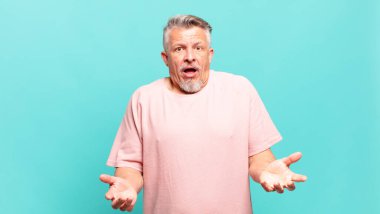 old senior man open-mouthed and amazed, shocked and astonished with an unbelievable surprise