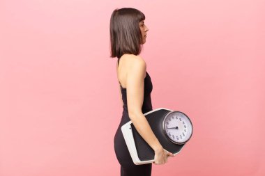 athlete woman on profile view looking to copy space ahead, thinking, imagining or daydreaming