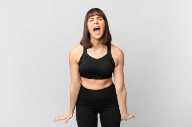 athlete woman shouting aggressively, looking very angry, frustrated, outraged or annoyed, screaming no