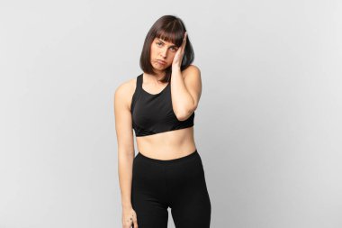 athlete woman feeling bored, frustrated and sleepy after a tiresome, dull and tedious task, holding face with hand