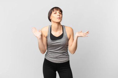 athlete woman feeling puzzled and confused, doubting, weighting or choosing different options with funny expression