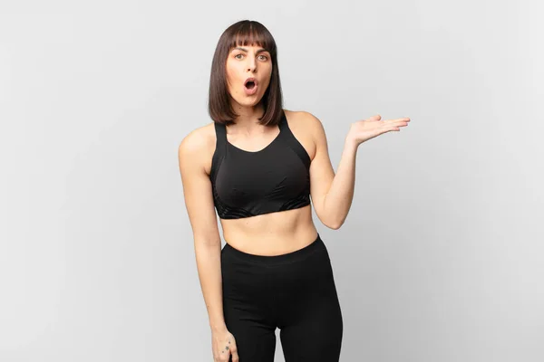 Athlete Woman Looking Surprised Shocked Jaw Dropped Holding Object Open — Stockfoto