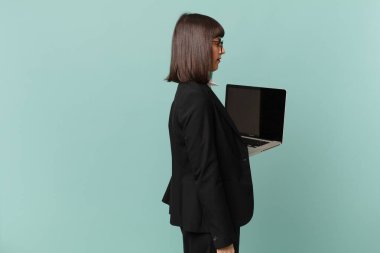 businesswoman on profile view looking to copy space ahead, thinking, imagining or daydreaming