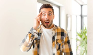 Yakışıklı adam şaşırmış, ağzı açık, şok olmuş, yeni bir düşünce, fikir ya da konsept keşfediyor.