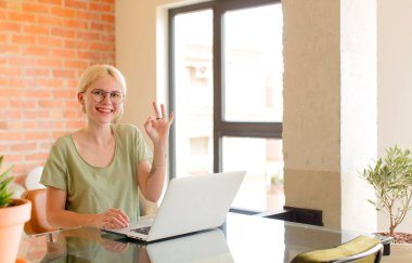 Güzel öğrenci kendini mutlu, rahat ve tatmin olmuş hissediyor. Onayını iyi bir hareketle gösteriyor. Gülümsüyor.