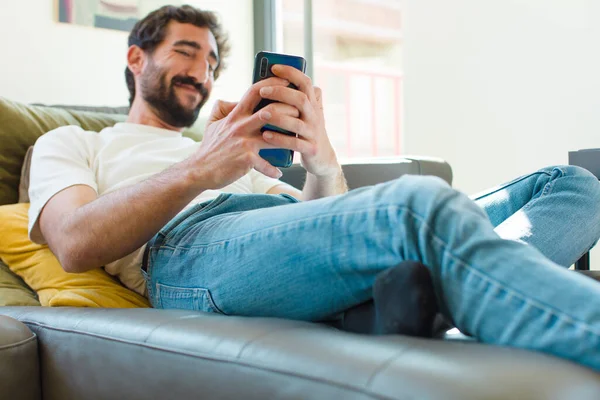 Young Bearded Man Resting Couch Smart Phone — Stock Photo, Image