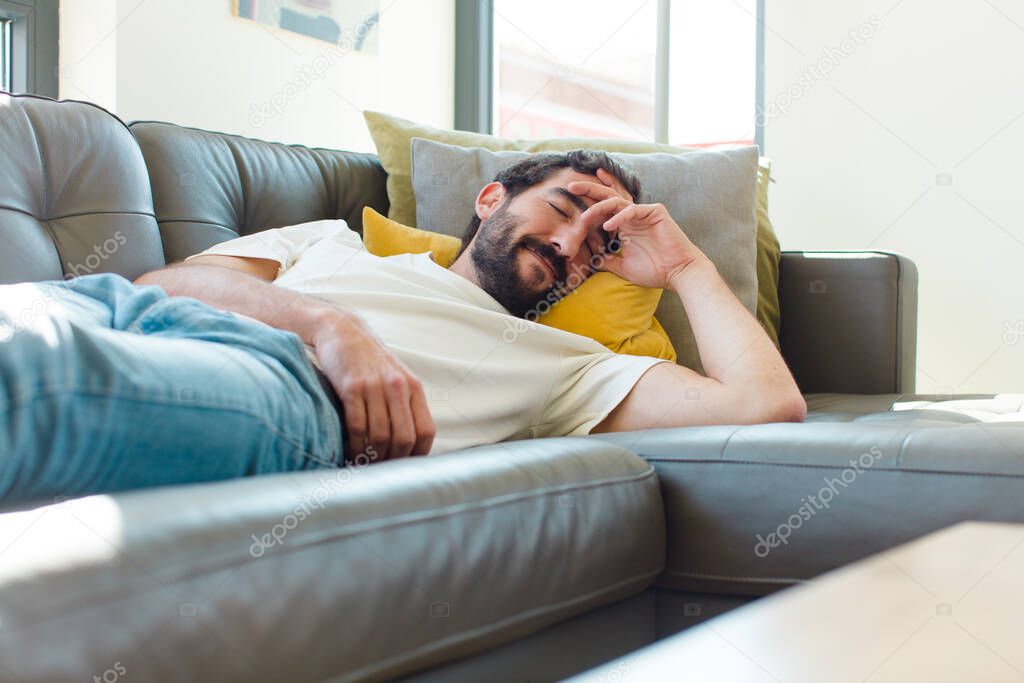 young bearded man resting on a couch