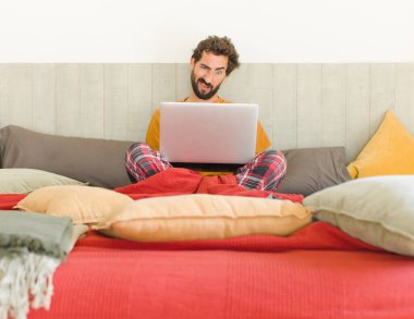 young bearded man feeling puzzled and confused, with a dumb, stunned expression looking at something unexpected