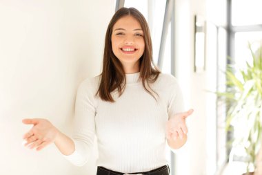 Güzel bir kadın neşeyle gülümsüyor sıcak, dostça, sevgi dolu bir kucak veriyor, mutlu ve sevimli hissediyor.