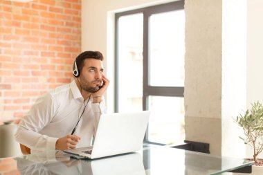 Yakışıklı pazarlamacı, yorgun, sıkıcı ve sıkıcı bir işten sonra sıkılmış, hayal kırıklığına uğramış ve uykulu hisseder.