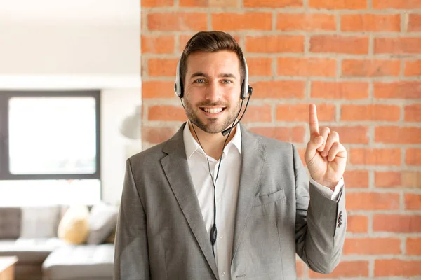 Handsome Telemarketer Smiling Looking Friendly Showing Number One First Hand — Stock Photo, Image