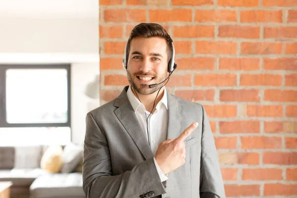 Handsome Telemarketer Smiling Cheerfully Feeling Happy Pointing Side Upwards Showing — Stock Photo, Image