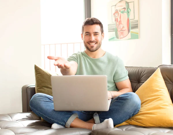 stock image handsome man smiling happily with friendly, confident, positive look, offering and showing an object or concept